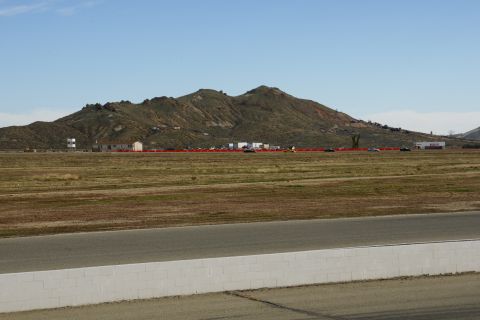 1995 Ford Taurus - A wide view of a race track and surrounding landscape with mountains in the background.