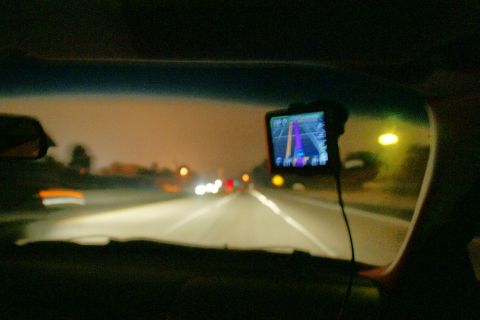 1995 Ford Taurus - Driving at night with a GPS device showing the route on the windshield.