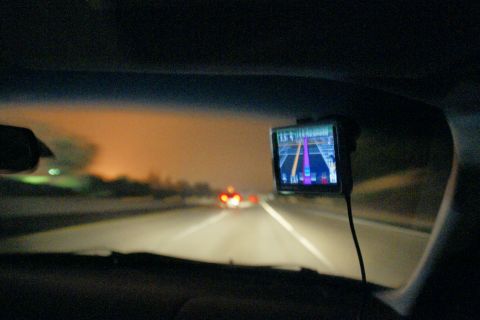 1995 Ford Taurus - Driving at night with a GPS device guiding the way on a highway.