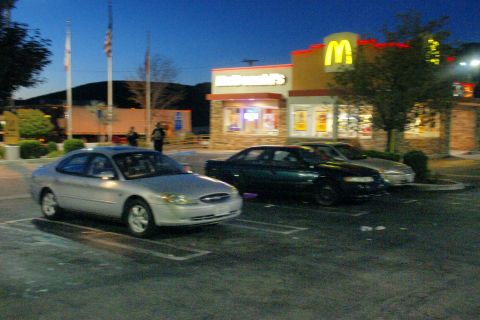 1995 Ford Taurus - Silver sedan parked in a lot at dusk with a McDonald's restaurant in the background.