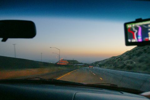 1995 Ford Taurus - Driving on a highway as the sun sets, with a GPS guiding the way.