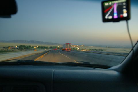1995 Ford Taurus - Driving on the highway as the sun sets, with a semi-truck in the distance and a GPS guiding the way.