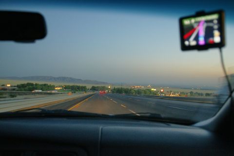 1995 Ford Taurus - Driving on the highway at dusk, with a GPS navigation system visible on the dashboard.