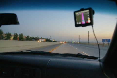1995 Ford Taurus - Driving on a highway at dusk, with a GPS navigation system mounted on the windshield.