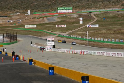1995 Ford Taurus - Willow Springs International Raceway features multiple cars on the track and various sponsor advertisements.