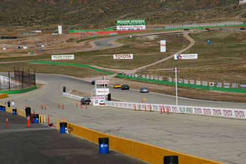 1995 Ford Taurus - Multiple vehicles race on a track with various sponsor advertisements visible.