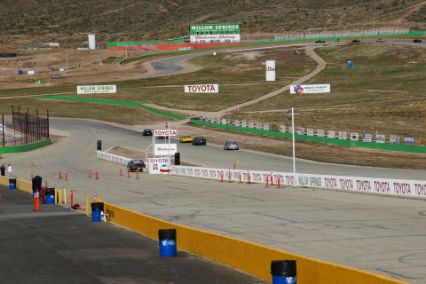 1995 Ford Taurus - Cars race on a track at Willow Springs, with Toyota signage prominent around the circuit.