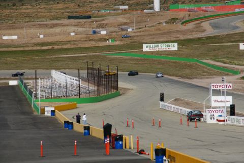 1995 Ford Taurus - Several cars are visible on the Willow Springs International Raceway, with prominent Toyota branding.