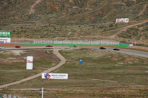 1995 Ford Taurus - Several cars are on a race track, with various advertisements visible in the background.