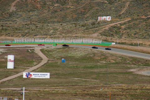 1995 Ford Taurus - Multiple vehicles race on a track with prominent Budweiser advertising in the background.