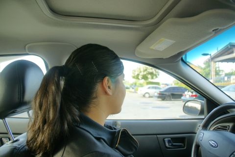 1995 Ford Taurus - View from inside a car, showing the driver and the parking lot outside through the window.