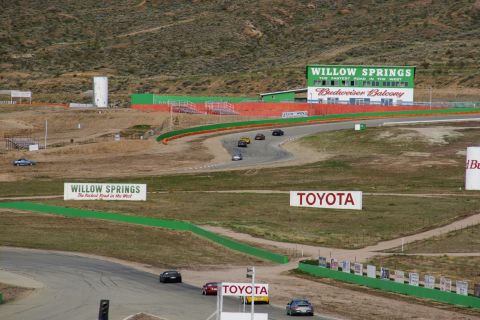 1995 Ford Taurus - Cars race on a track with Willow Springs and Toyota signage visible in the background.