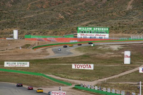 1995 Ford Taurus - Cars race on a track with grandstands and signs for Willow Springs and Toyota.