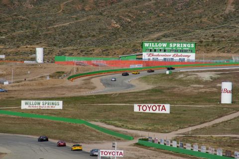 1995 Ford Taurus - Multiple cars are seen on the Willow Springs International Raceway circuit.