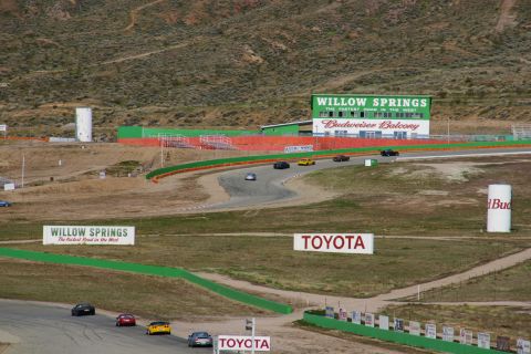 1995 Ford Taurus - Multiple cars compete on a race track, with prominent Willow Springs and Toyota branding.