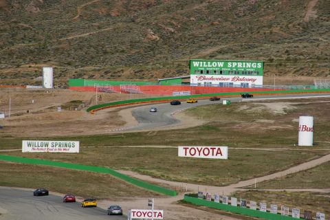 1995 Ford Taurus - Cars race on the track at Willow Springs, with prominent "Willow Springs" and "Toyota" signs visible.