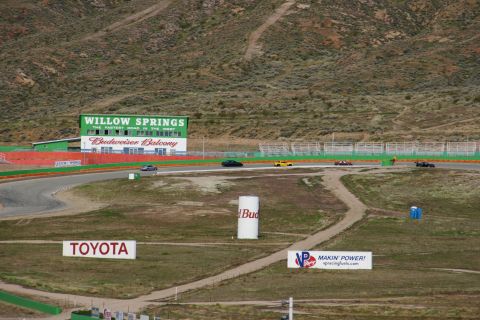 1995 Ford Taurus - Multiple cars race on a track with Willow Springs and Budweiser signage visible in the background.