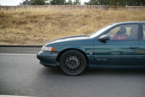 1995 Ford Taurus - A 1995 Ford Taurus sedan is seen from the side while driving on a highway.