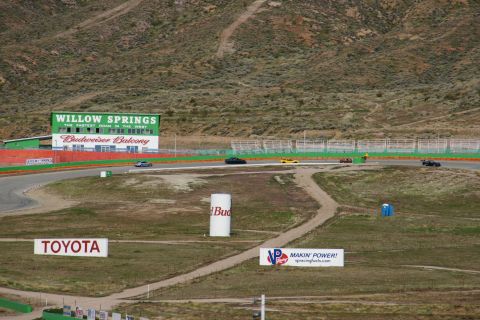1995 Ford Taurus - Cars race on the Willow Springs track, with the Budweiser Balcony grandstands in the background.