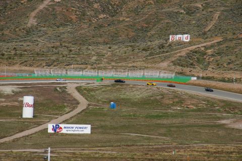 1995 Ford Taurus - Cars compete on a race track, with advertising signs visible in the foreground and hills in the background.