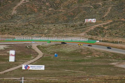 1995 Ford Taurus - Cars are seen racing on a track with advertising signs visible in the surrounding landscape.