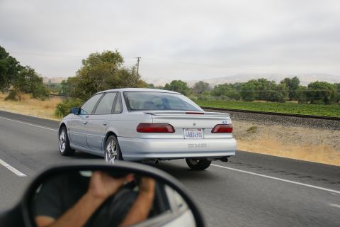 1995 Ford Taurus - Silver 1995 Ford Taurus seen from another vehicle on a highway.