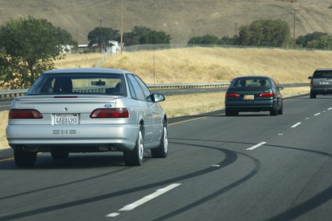 1995 Ford Taurus - Silver 1995 Ford Taurus on the highway with other vehicles.