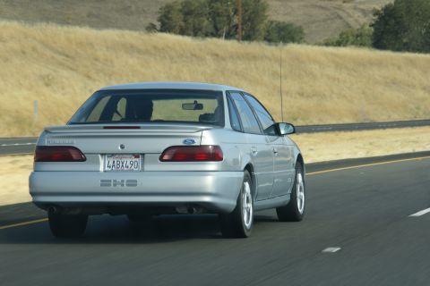 1995 Ford Taurus - Rear view of a silver 1995 Ford Taurus SHO on the highway.