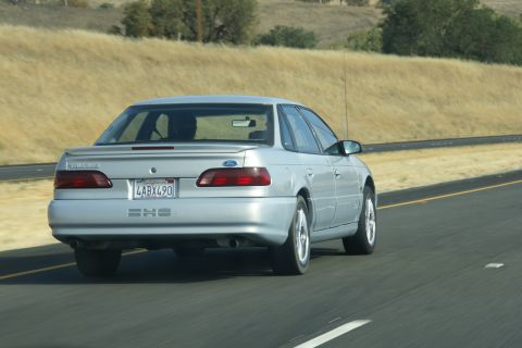 1995 Ford Taurus - Rear view of a silver 1995 Ford Taurus on the highway.