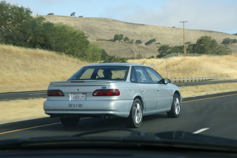 1995 Ford Taurus - Rear view of a silver 1995 Ford Taurus sedan on a highway.
