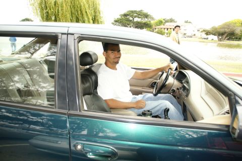 1995 Ford Taurus - Interior view of a 1995 Ford Taurus with a man driving, seen from the passenger side.