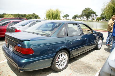 1995 Ford Taurus - This 1995 Ford Taurus sedan is seen from a 3/4 front angle, parked near a body of water.