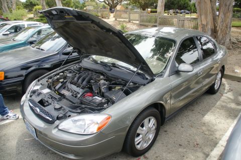 1995 Ford Taurus - A gray sedan, likely a Ford Taurus from the early 2000s, is parked with its hood open.