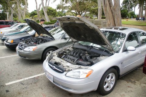 1995 Ford Taurus - A silver sedan, likely from the early 2000s, has its hood open to reveal the engine compartment.