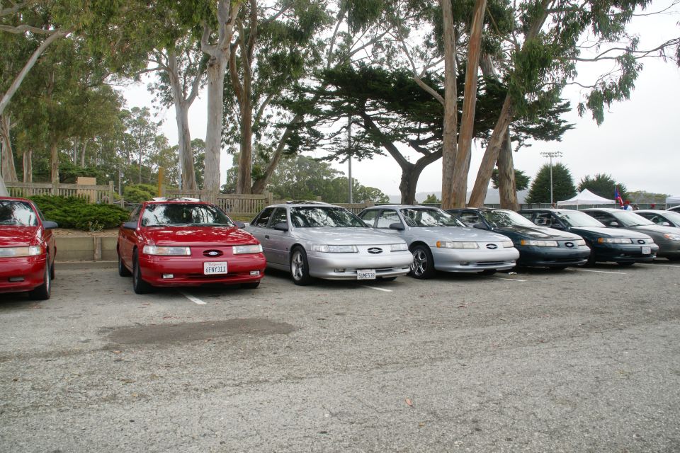 1995 Ford Taurus sedans parked in a row, front view. Red and silver