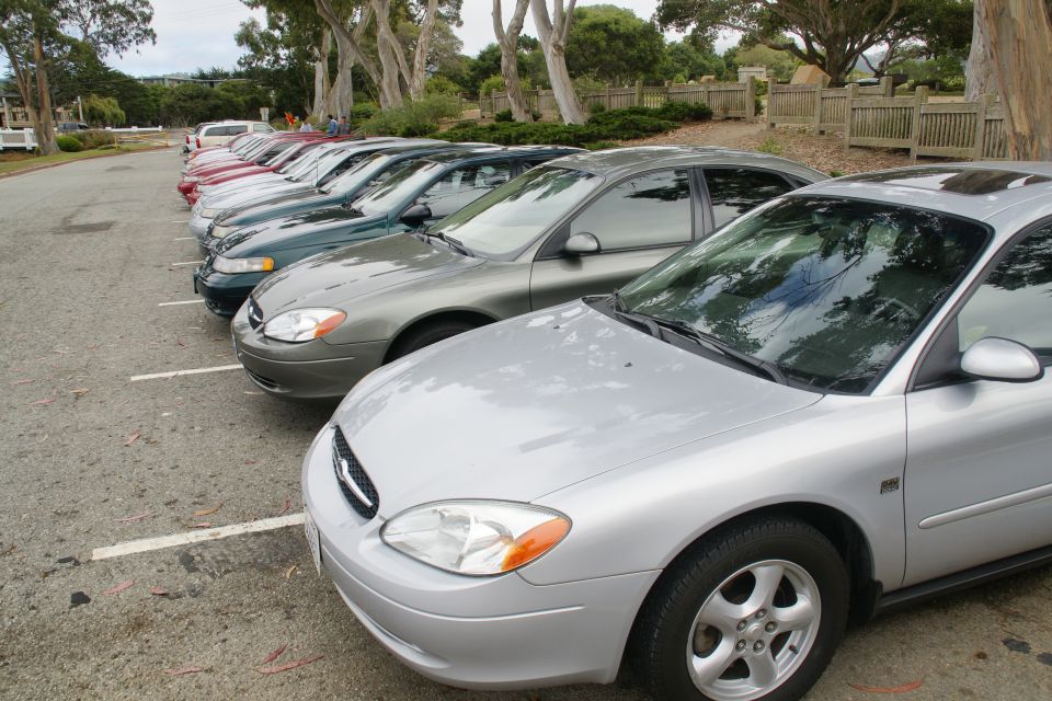 Silver sedan parked in a lot, front quarter view. The car has a sunroof and alloy wheels