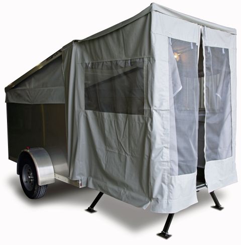 1996 Ford Bronco - A pop-up camper trailer is set up with its canvas walls extended and doors open.