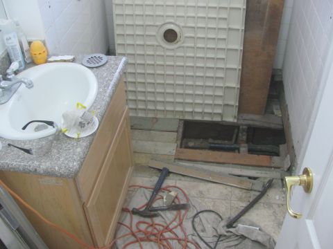 1968 Ford Mustang - Bathroom renovation in progress, showing a sink, vanity, and a disassembled shower area with tools on the floor.