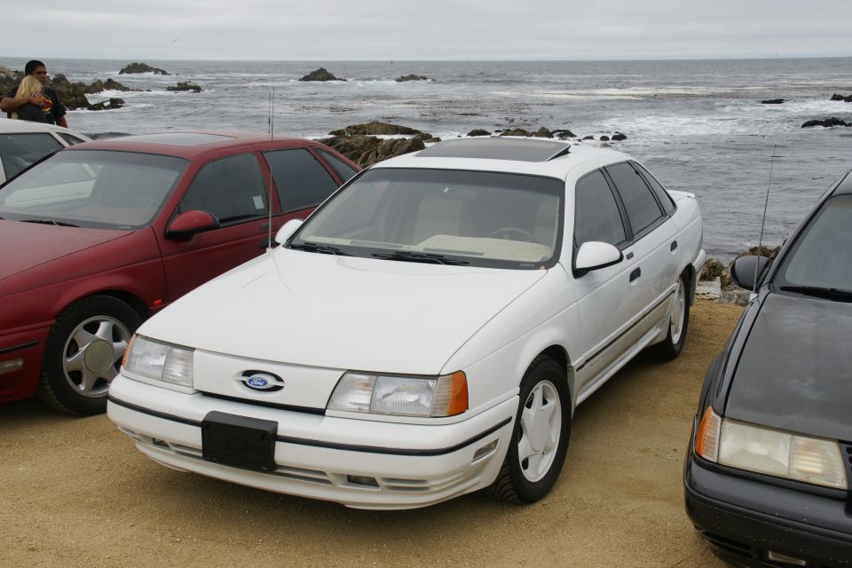 White 1995 Ford Taurus sedan parked by the ocean