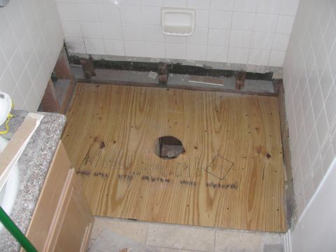 1968 Ford Mustang - Bathroom floor renovation in progress, showing exposed subfloor and unfinished walls.