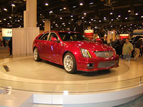 2012 Ford Crown Victoria - A red Cadillac CTS wagon is showcased at an auto show.