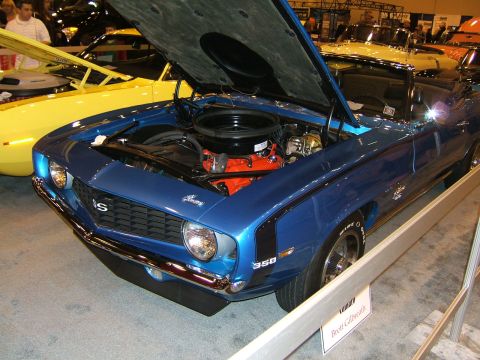 2012 Ford Crown Victoria - A blue muscle car is displayed with its hood open, revealing the engine compartment.