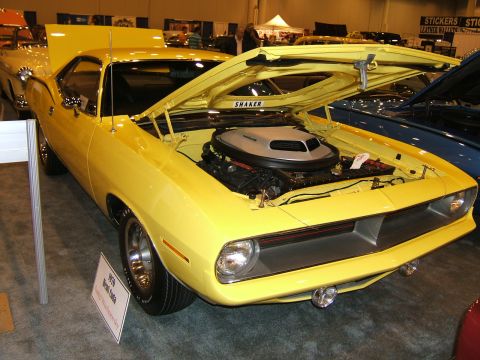 2012 Ford Crown Victoria - Yellow muscle car on display, hood open to reveal the engine compartment.