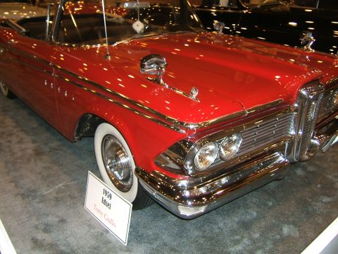 2012 Ford Crown Victoria - A red convertible with whitewall tires is parked indoors.