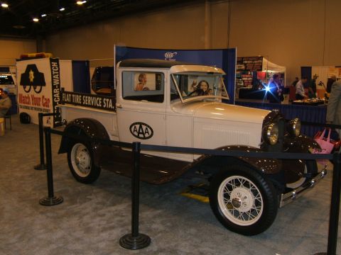 2012 Ford Crown Victoria - A vintage automobile, likely from the 1920s, is displayed indoors with its front three-quarter view visible.
