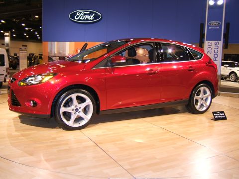 2012 Ford Crown Victoria - A red sedan is displayed indoors, likely at an auto show event.