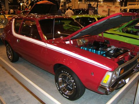 2012 Ford Crown Victoria - Red car with hood open, revealing the engine compartment. White stripe runs along the side.