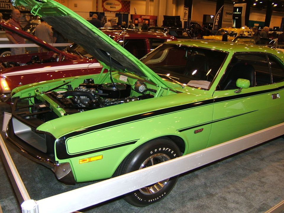 Lime green muscle car with black stripes, hood open