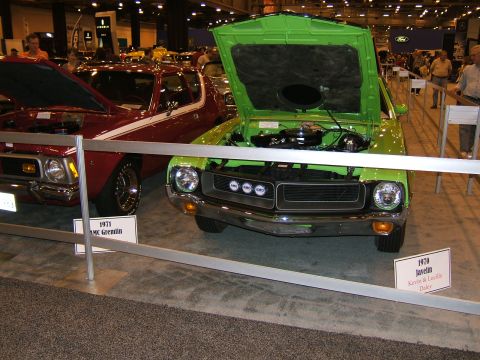 2012 Ford Crown Victoria - A green car is displayed with its hood open at what appears to be an auto show.