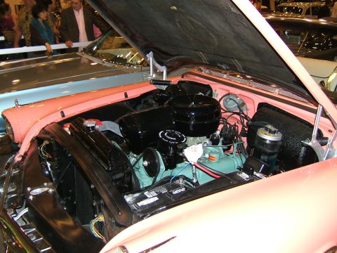 2012 Ford Crown Victoria - The engine bay of a vintage car is open for viewing at an auto show.